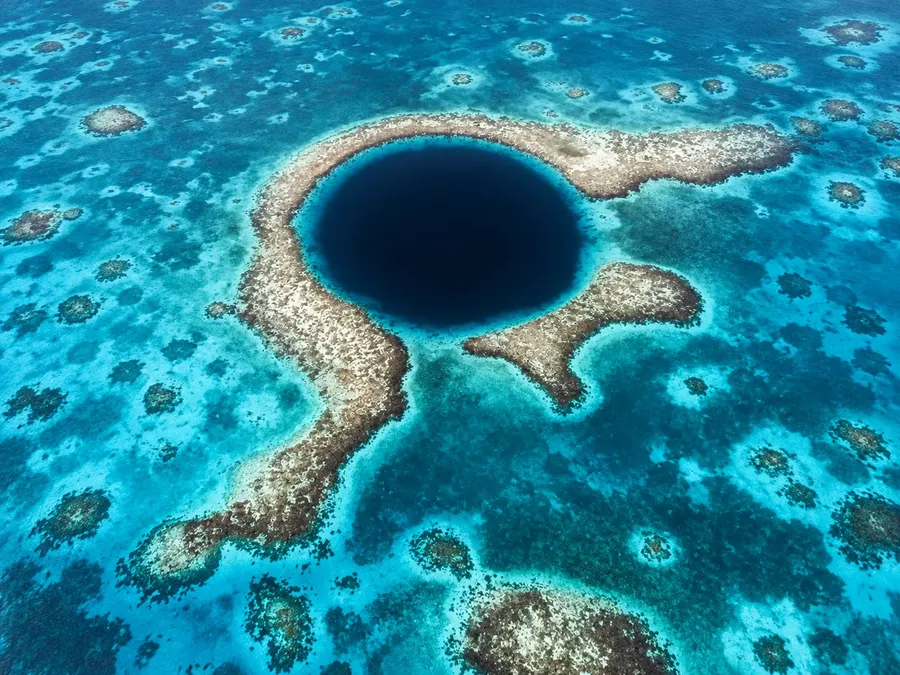 A deep blue hole ringed by reef in the Berry Islands, seen from the air