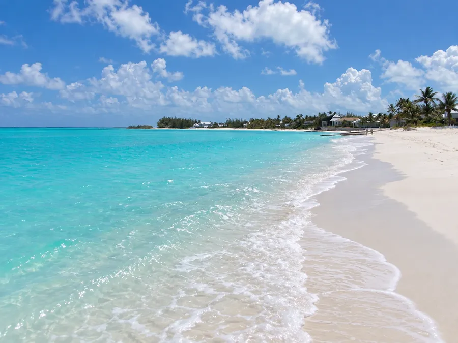 The long white sand beach at Treasure Cay in the Abacos, clear turquoise water washing up along the shore